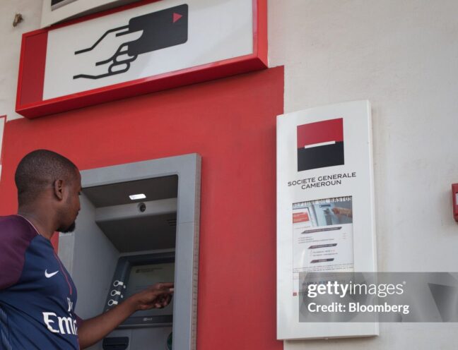 A customer uses an automated teller machine (ATM) at a branch of Societe Generale de Banques au Cameroun in Yaounde, Cameroon, on Tuesday, June 5, 2018. Cameroon adjusted its 2018 budget to 4.69 trillion CFA francs ($8.1 billion) from 4.51 trillion francs as it forecasts an increase in oil revenue, value-added tax, and loans and grants. Photographer: Adrienne Surprenant/Bloomberg via Getty Images